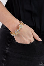 Load image into Gallery viewer, Featuring a wheel motif, concaved gold discs embossed in an explosion of iridescent rhinestones slide along a stretchy band around the wrist for a hint of dazzling refinement. Due to its prismatic palette, color may vary.  Sold as one individual bracelet.
