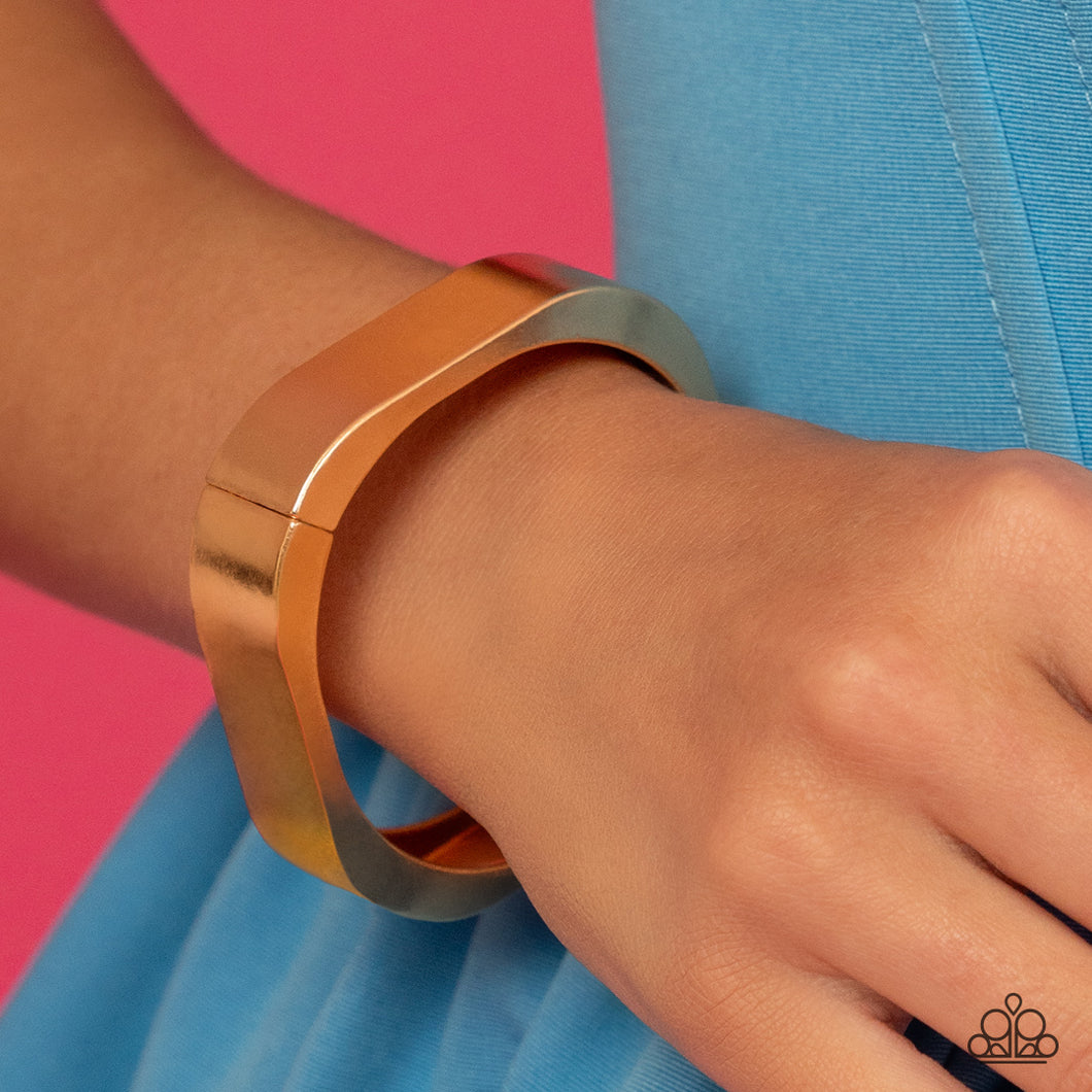 Featuring a sleek, high-sheen finish, a thick gold cuff asymmetrically wraps around the wrist, creating a tilted square centerpiece for a monochromatic staple. Features a hinged closure.  Sold as one individual bracelet.
