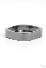 Load image into Gallery viewer, Featuring a sleek, high-sheen finish, a thick gunmetal cuff asymmetrically wraps around the wrist, creating a tilted square centerpiece for a monochromatic staple. Features a hinged closure. Sold as one individual bracelet.
