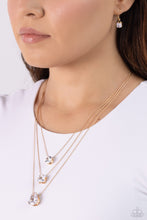 Load image into Gallery viewer, Featuring a subtle iridescent finish, exaggerated, faceted round, square, and teardrop gems layer down the chest from three sleek gold dainty chains, in a refined fashion. Features an adjustable clasp closure. Due to its prismatic palette, color may vary.  Sold as one individual necklace. Includes one pair of matching earrings.
