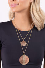 Load image into Gallery viewer, Two strands of classic gold chains fall into tiered layers as they cascade down the chest. Varying sizes of gold discs hammered in rippling texture and painted with a glossy Iced Coffee and brown slide along each chain in a dizzying display, with a thin line of gold peeking at the center of the lowermost exaggerated pendant.  Sold as one individual necklace. Includes one pair of matching earrings.
