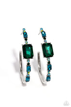 Load image into Gallery viewer, Encrusted in round and emerald-cut aquamarine and emerald gems, some featuring an iridescent sheen, an exaggerated oblong silver hoop curls around the ear, refracting light in a dramatic, knockout finish. Earring attaches to a standard post fitting. Hoop measures approximately 2&quot; long. Due to its prismatic palette, color may vary.  Sold as one pair of hoop earrings.

