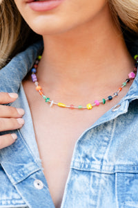 Infused on an invisible wire, an assortment of multicolored beads, acrylics, and chiseled stones alternating with dainty silver rods coalesce around the neckline for a youthful pop of color. Features an adjustable clasp closure. As the stone elements in this piece are natural, some color variation is normal.  Sold as one individual necklace. Includes one pair of matching earrings.