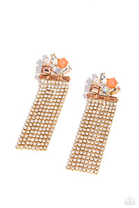 Featuring pronged gold fittings, a trio of peachy emerald-cut gems lay across the ear in a horizontal manner. Various peachy, white, and iridescent gems and a milky orange bead and white pearl haphazardly cluster up the ear from the horizontal layer for additional eye-catching detail. Strands of white rhinestones in sleek gold square fittings cascade from the emerald-cut layer, creating freefalling glitzy movement. Earring attaches to a standard post fitting.  Sold as one pair of post earrings.