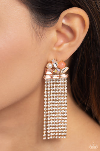Featuring pronged gold fittings, a trio of peachy emerald-cut gems lay across the ear in a horizontal manner. Various peachy, white, and iridescent gems and a milky orange bead and white pearl haphazardly cluster up the ear from the horizontal layer for additional eye-catching detail. Strands of white rhinestones in sleek gold square fittings cascade from the emerald-cut layer, creating freefalling glitzy movement. Earring attaches to a standard post fitting.  Sold as one pair of post earrings.