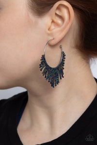 Cascading strands of oil spill seed beads stream out from the bottom of a classic silver hoop, resulting in a flirtatiously tasseled look. Earring attaches to a standard post fitting. Hoop measures approximately 1 1/2" in diameter.  Sold as one pair of hoop earrings.