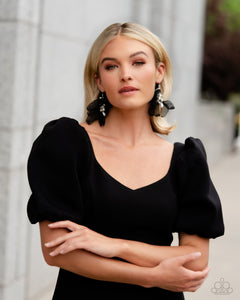Featuring a layered motif, elongated black silk petals are separated by a sprinkle of white gems in silver fittings that mingle with a cluster of dreamy white pearls, creating a high-society fringe. Earring attaches to a standard fishhook fitting.  Sold as one pair of earrings. Earrings are on a model.