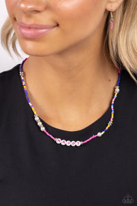 Infused along an invisible string, white pearls, multicolored seed beads, silver accents, and white beads spelling out the word "HAPPY" in pink lettering wrap around the neckline for an optimistic, youthful display. Features an adjustable clasp closure.  Sold as one individual necklace. Includes one pair of matching earrings.