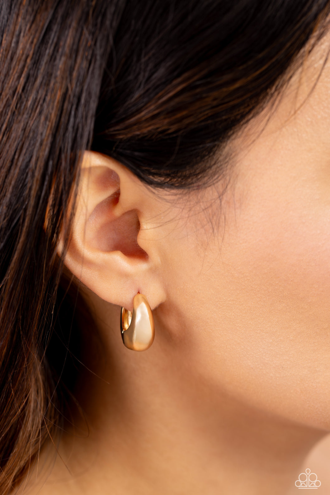 Featuring a beveled surface, a thick gold hoop snugly curls around the ear for a dainty, sleek basic look. Earring attaches to a standard hinge closure fitting. Hoop measures approximately 3/4