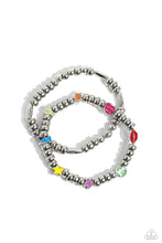 Load image into Gallery viewer, A strand of textured, cylindrical, and round high-sheen silver beads combine with a single strand of silver beads, sporadically infused with vivacious charm beads to create an energetic stack of stretchy bracelets. The colorful beaded stack features a yellow star, blue lightning bolt, green money bag, orange tropical flower, red lips, blue and green earth, pink and purple flower, and a pink heart charm with the words &quot;love me&quot; for a youthful finish.  Sold as one set of two bracelets.
