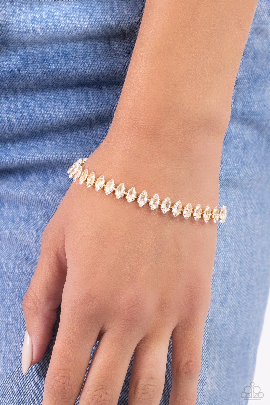 Featuring gold square fittings, crystal-like marquise-cut gems delicately link into a glamorous, refined centerpiece around the wrist. Features an adjustable clasp closure.  Sold as one individual bracelet