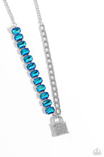 Load image into Gallery viewer, Infused on a classic silver chain, a strand of thick silver curb chain, and a collection of exaggerated, blue UV radiant-cut gems in silver pronged fittings combine to create a collision of industrial color around the neckline. An oversized silver lock charm, embossed in white rhinestones, dangles from the gritty display for a touch of soft glitz to the design. Features an adjustable clasp closure.  Sold as one individual necklace. Includes one pair of matching earrings.
