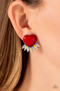 A red heart pressed in a sleek silver frame stands out at the ear. Textured silver leaves flare out from a curved cluster of turquoise and yellow beads that adorn the bottom of the heart display, creating a spring-inspired fringe. Earring attaches to a standard clip-on fitting.   Featured inside The Preview at Made for More! Sold as one pair of clip-on earrings.