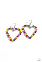 Load image into Gallery viewer, A vibrant collection of Rose Violet, Kohlrabi, purple, yellow, and coral seed beads are wrapped along the outside curve of a shiny, silver heart frame by shimmery silver wire for a handcrafted, fun-loving finish. Earring attaches to a standard fishhook fitting.  Sold as one pair of earrings.
