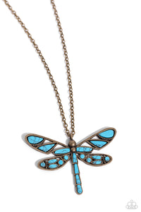 Featuring a classic brass chain, various cuts of turquoise stone are passed into an oversized, airy brass dragonfly pendant for a rustically earthy centerpiece. Features an adjustable clasp closure. As the stone elements in this piece are natural, some color variation is normal.  Sold as one individual necklace. Includes one pair of matching earrings.