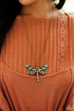 Load image into Gallery viewer, Featuring a classic brass chain, various cuts of turquoise stone are passed into an oversized, airy brass dragonfly pendant for a rustically earthy centerpiece. Features an adjustable clasp closure. As the stone elements in this piece are natural, some color variation is normal.  Sold as one individual necklace. Includes one pair of matching earrings.
