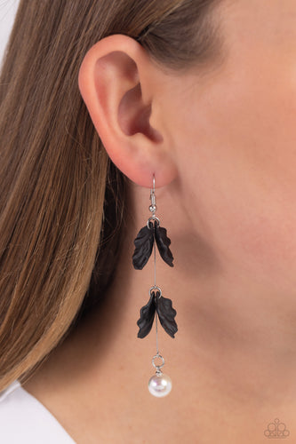 A glossy white pearl delicately links to the bottom of a sleek silver rod. Black acrylic petals cascade along the silver rod, adding a timeless twist to the classic pearl palette. Earring attaches to a standard fishhook fitting. Sold as one pair of earrings.