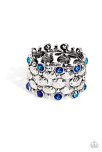 Load image into Gallery viewer, A collection of hammered oval silver beads, sleek silver beads, and blue UV beads are threaded along stretchy bands around the wrist, creating a zigzag pattern of edge. Due to its prismatic palette, color may vary.   Featured inside The Preview at Made for More! Sold as one individual bracelet.
