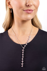 Featuring pronged fittings, a collection of baby pink square-cut, heart, oval, round, and teardrop gems cascade down the neckline in a diagonal pattern, creating an intense, incandescent statement piece. Features an adjustable clasp closure.  Sold as one individual necklace. Includes one pair of matching earrings.