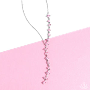 Featuring pronged fittings, a collection of baby pink square-cut, heart, oval, round, and teardrop gems cascade down the neckline in a diagonal pattern, creating an intense, incandescent statement piece. Features an adjustable clasp closure.  Sold as one individual necklace. Includes one pair of matching earrings.