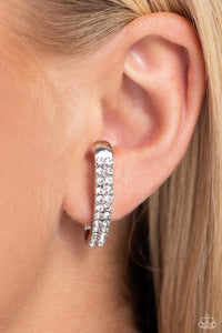 Two rows of glassy white rhinestones are set along the center of a curved silver bar for a refined display of dazzle. Features a sleek surface for sliding ability to desired position on the ear. Due to its structure, adjusting capability is limited.  Sold as one pair of illusion post earrings.