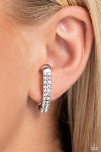 Two rows of glassy white rhinestones are set along the center of a curved silver bar for a refined display of dazzle. Features a sleek surface for sliding ability to desired position on the ear. Due to its structure, adjusting capability is limited.  Sold as one pair of illusion post earrings.