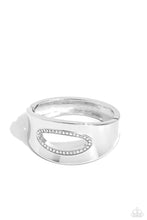 Load image into Gallery viewer, Featuring an airy asymmetrical, white rhinestone-encrusted cutout, a sleek silver cuff with beveled edges wraps around the wrist for a bold, refined look. Features a hinged closure.  Sold as one individual bracelet.
