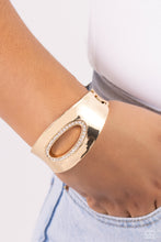 Load image into Gallery viewer, Featuring an airy asymmetrical, white rhinestone-encrusted cutout, a sleek gold cuff with beveled edges wraps around the wrist for a bold, refined look. Features a hinged closure.  Sold as one individual bracelet.
