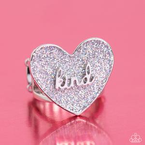 Brushed in a glittery iridescent finish, a gray heart frame rests atop airy silver bands for a retro glamorous look. The word "kind" is centered atop the heart frame for an optimistic finish. Features a stretchy band for a flexible fit.  Sold as one individual ring.