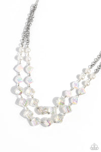 Featuring a subtle scratch surface, a bubbly collection of white pearls, abstract iridescent beads, and sparkly crystal-like iridescent beads are threaded along metallic rods that trickle in a two-layer display, creating an elegantly effervescent display below the collar. Features an adjustable clasp closure. Due to its prismatic palette, color may vary.  Sold as one individual necklace. Includes one pair of matching earrings.