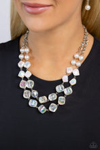 Load image into Gallery viewer, Featuring a subtle scratch surface, a bubbly collection of white pearls, abstract iridescent beads, and sparkly crystal-like iridescent beads are threaded along metallic rods that trickle in a two-layer display, creating an elegantly effervescent display below the collar. Features an adjustable clasp closure. Due to its prismatic palette, color may vary.  Sold as one individual necklace. Includes one pair of matching earrings.
