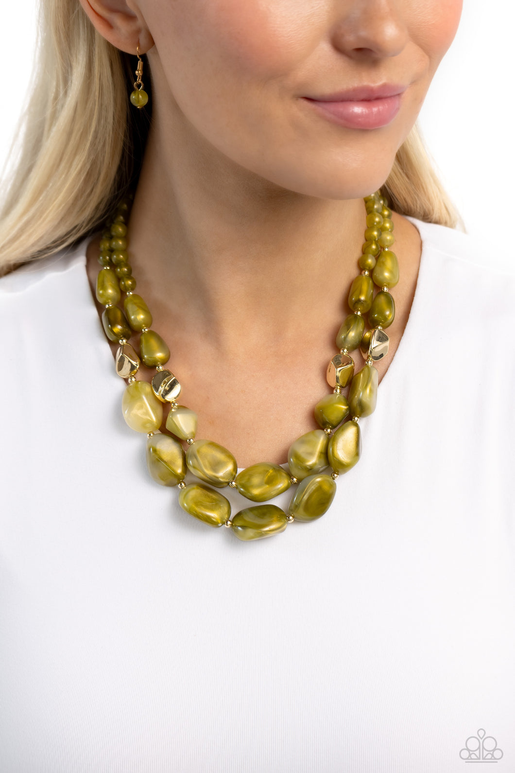 Varying in shape and opacity, a refreshing collection of sparkle-infused green beads layer below the collar for a boldly colorful look. Accents of faceted gold beads and gold studs are infused throughout the design for a subtle touch of additional sheen. Features an adjustable clasp closure.  Sold as one individual necklace. Includes one pair of matching earrings.