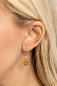 Varying in shape and opacity, a refreshing collection of sparkle-infused green beads layer below the collar for a boldly colorful look. Accents of faceted gold beads and gold studs are infused throughout the design for a subtle touch of additional sheen. Features an adjustable clasp closure.  Sold as one individual necklace. Includes one pair of matching earrings.