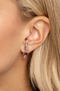 A trendy collection of rose, fuchsia, pink, and iridescent round and teardrop rhinestones and gems are pronged in place along a curved silver bar. Features a sleek surface for sliding ability to desired position on the ear. Due to its structure, adjusting capability is limited. Due to its prismatic palette, color may vary.  Sold as one pair of illusion post earrings.