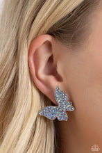 Load image into Gallery viewer, Featuring a tilted motif, a silver butterfly encrusted with an explosion of blue iridescent rhinestones sparkles at the ear for an enchanting fashion. Earring attaches to a standard post fitting. Due to its prismatic palette, color may vary.  Featured inside The Preview at Made for More! Sold as one pair of post earrings.
