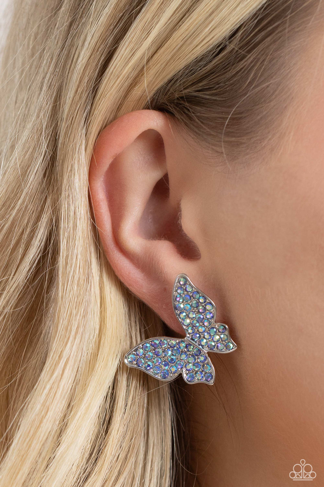 Featuring a tilted motif, a silver butterfly encrusted with an explosion of blue iridescent rhinestones sparkles at the ear for an enchanting fashion. Earring attaches to a standard post fitting. Due to its prismatic palette, color may vary.  Featured inside The Preview at Made for More! Sold as one pair of post earrings.