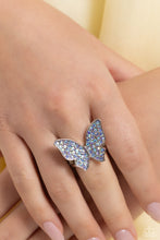 Load image into Gallery viewer, Ring: Featured atop airy silver bands, a silver butterfly encrusted with an explosion of blue iridescent rhinestones sparkles at the finger for an enchanting fashion. Features a stretchy band for a flexible fit. Earrings: Featuring a tilted motif, a silver butterfly encrusted with an explosion of blue iridescent rhinestones sparkles at the ear for an enchanting fashion. Earring attaches to a standard post fitting. Due to its prismatic palette, color may vary.  Featured inside The Preview at Made for More! 
