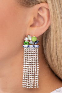 Featuring pronged silver fittings, a trio of blue emerald-cut gems lay across the ear in a horizontal manner. Various green, white, and blue gems and a milky green bead and white pearl haphazardly cluster up the ear from the horizontal layer for additional eye-catching detail. Strands of white rhinestones in sleek silver square fittings cascade from the emerald-cut layer, creating freefalling glitzy movement. Earring attaches to a standard post fitting.  Sold as one pair of post earrings.