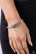 Load image into Gallery viewer, Infused on an elastic stretchy band, white pearls, gray, hot pink, and yellow seed beads, silver studs, and gray beads spelling out the word &quot;LOVE&quot; with a yellow heart bead aside it wraps around the wrist for a sentimental, youthful display.  Sold as one individual bracelet.
