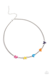Infused along a silver popcorn chain, multicolored-painted letters spell out the phrase "HAPPY" for an optimistic style. Features an adjustable clasp closure.  Sold as one individual necklace. Includes one pair of matching earrings.