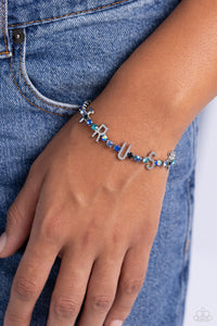 Set in silver square fittings, various multicolored rhinestones gleam around the wrist. Infused along the design, sleek silver letters spell out the word "TRUST" for an inspirational finish. Features an adjustable clasp closure. Due to its prismatic palette, color may vary.  Sold as one individual bracelet.