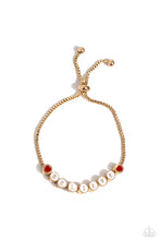 Load image into Gallery viewer,  Delicately attached to a dainty gold box chain, thick circular gold fittings spell out the word &quot;BELIEVE&quot; across a white-painted backdrop with red-painted hearts embellishing the ends of the word, creating a sleek inspiring display. Features an adjustable sliding bead closure.  Sold as one individual bracelet. 
