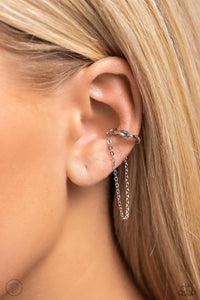 A glistening silver bar delicately twists into a dainty hoop while a solitaire shimmery silver chain cascades below it, creating an adjustable refined, one-size-fits-all display.  Sold as one pair of cuff earrings.
