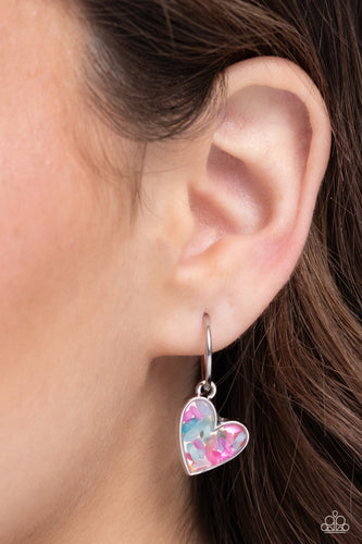 A small, skinny, silver hoop curves around the ear in a timeless fashion with a silver ball affixed to the end of the hoop, reminiscent of a barbell fitting. A silver heart frame, encased with haphazardly patterned pink and turquoise flecks of shell, collides into a kaleidoscope of color for a colorful, shimmery statement. Earring attaches to a standard post fitting. Hoop measures approximately 1/2