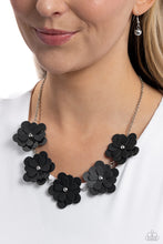 Load image into Gallery viewer, Featuring silver stud centers, a collection of 3D black leather flowers connect to a classic silver chain for a ruggedly retro look. Features an adjustable clasp closure. Sold as one individual necklace. Includes one pair of matching earrings.
