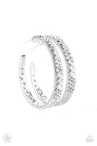 The front facing surface of a chunky silver hoop is dipped in brilliantly sparkling rhinestones while light-catching texture wraps around the back. The interior of the hoop features the opposite pattern, creating the illusion of a full hoop of blinding Blockbuster rhinestones. Earring attaches to a standard post fitting. Hoop measures 1 3/4" in diameter.  Sold as one pair of hoop earrings.