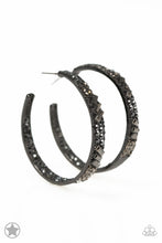 Load image into Gallery viewer, The front facing surface of a chunky black hoop is dipped in brilliantly sparkling hematite rhinestones while light-catching texture wraps around the back. The interior of the hoop features the opposite pattern, creating the illusion of a full hoop of blinding Blockbuster shimmer. Earring attaches to a standard post fitting. Hoop measures 1 3/4&quot; in diameter.  Sold as one pair of hoop earrings.
