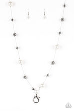 Load image into Gallery viewer, Infused with pearly white accents, classic silver and delicately hammered silver beads trickle along an elegantly elongated silver chain for a refined look. A lobster clasp hangs from the bottom of the design to allow a name badge or other item to be attached. Features an adjustable clasp closure. Sold as one individual lanyard. Includes one pair of matching earrings.

