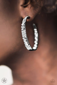 The front facing surface of a chunky gunmetal hoop is dipped in brilliantly sparkling rhinestones while light-catching texture wraps around the back. The interior of the hoop features the opposite pattern, creating the illusion of a full hoop of blinding Blockbuster rhinestones. Earring attaches to a standard post fitting. Hoop measures 1 3/4" in diameter.  Sold as one pair of hoop earrings