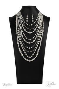 An elegant collection of timeless white pearls, shiny sections of silver chain, and bedazzling white rhinestone encrusted silver beads effortlessly cascade down the chest. The vintage inspired layers drape into breathtaking rows of radiance, resulting in an irresistible collision of romance. Features an adjustable clasp closure.